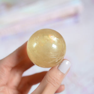 honey calcite with rainbows | sphere A