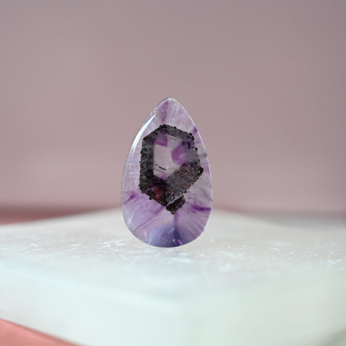 phantom amethyst cabochon with tourmaline inclusions