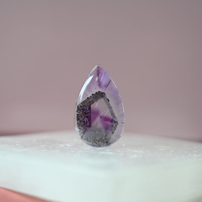 phantom amethyst cabochon with tourmaline inclusions