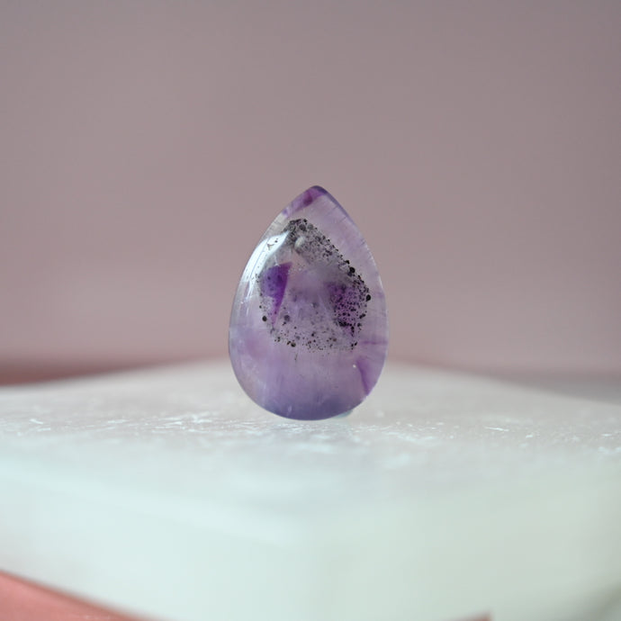 phantom amethyst cabochon with tourmaline inclusions