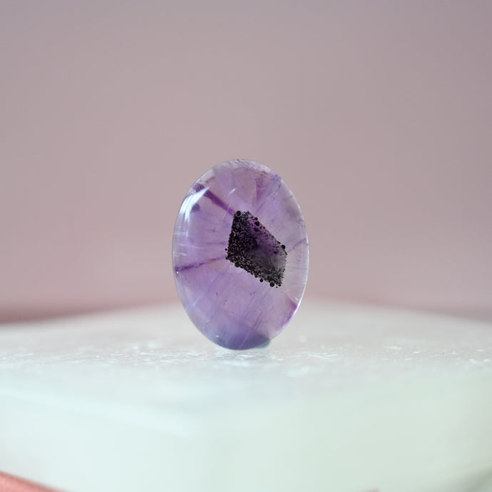 phantom amethyst cabochon with tourmaline inclusions