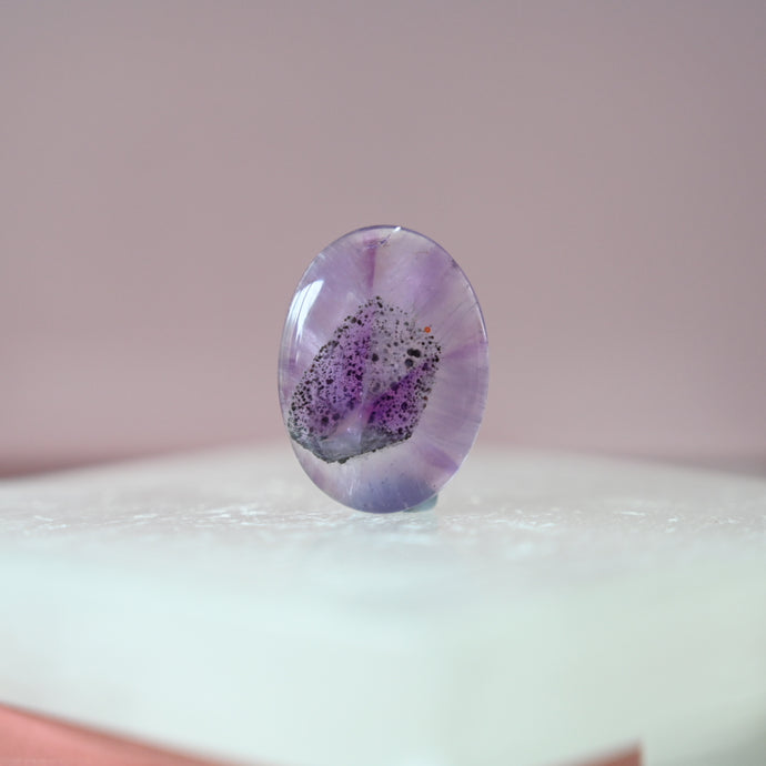 phantom amethyst cabochon with tourmaline inclusions