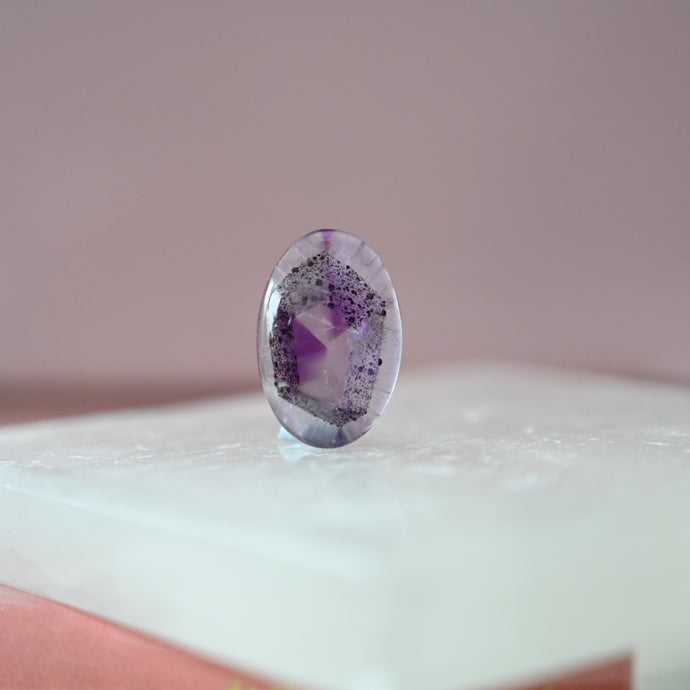 phantom amethyst cabochon with tourmaline inclusions