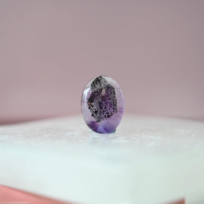 phantom amethyst cabochon with tourmaline inclusions